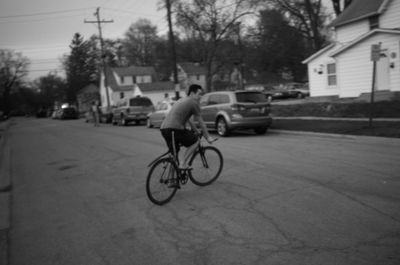 Man riding bicycle on street in city