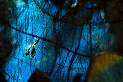 Low angle view of illuminated blue sky at night