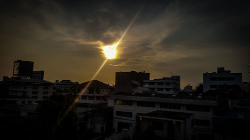 Buildings in city against sky during sunset