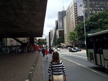 People walking on street amidst buildings