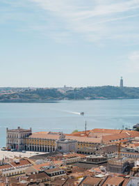 High angle view of townscape by sea against sky