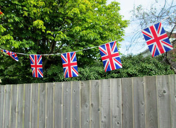 Close-up of flags against trees