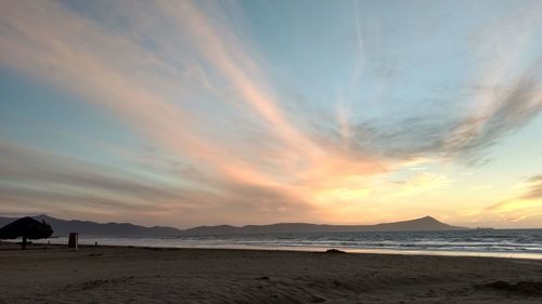 Scenic view of beach against sky during sunset