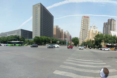 City street and modern buildings against sky