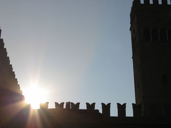 Low angle view of silhouette buildings against sky during sunset