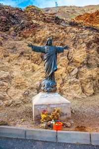 Sculpture of buddha statue on mountain