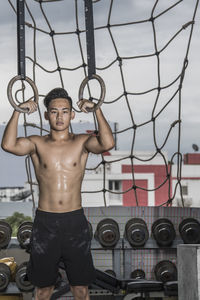 Man training at rooftop gym in bangkok