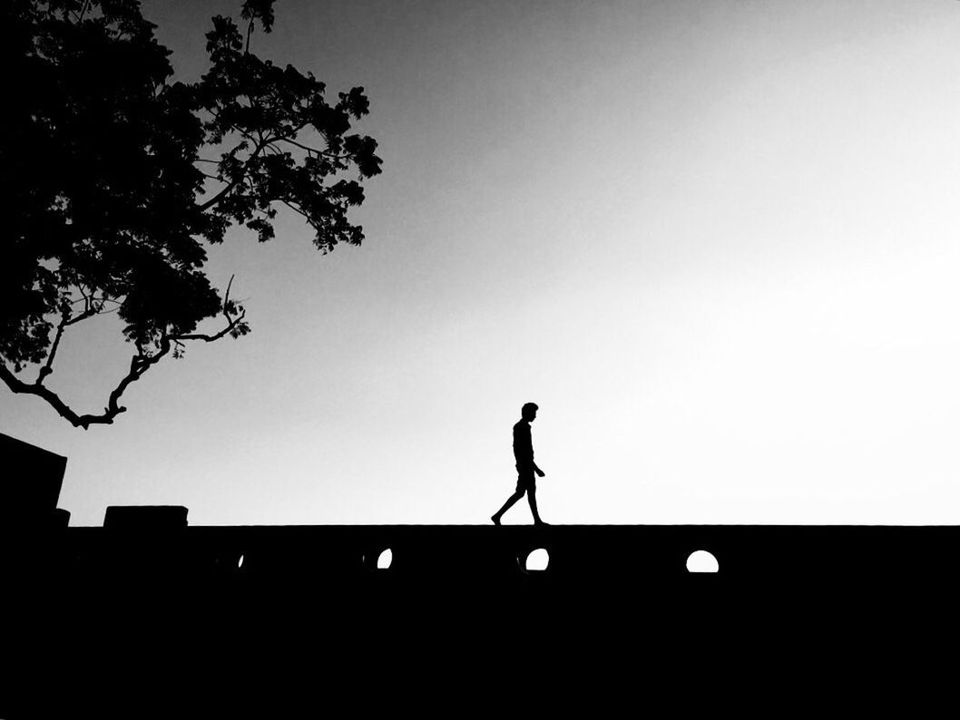 SILHOUETTE OF MAN AGAINST SKY