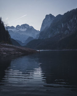 Scenic view of lake and mountains against sky
