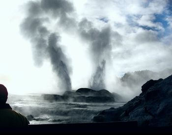 Scenic view of waterfall against sky