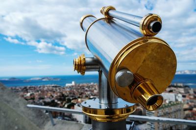 Close-up of binoculars against sky