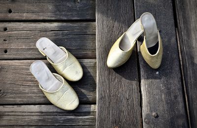 High angle view of shoes on wooden table