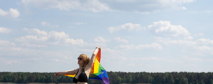 Woman standing on field against sky