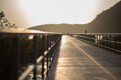 Surface level of footbridge against clear sky