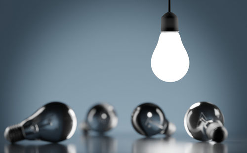 Close-up of light bulb hanging from ceiling