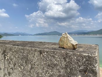 Rocks on beach against sky