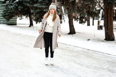 Rear view of woman walking on snow