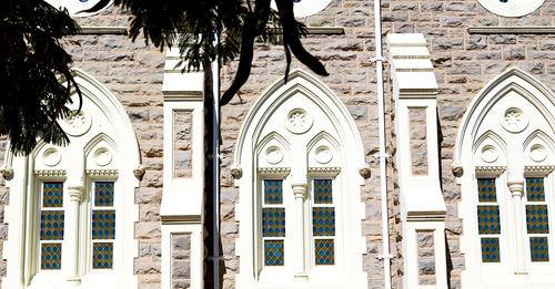 Low angle view of ornate hanging outside building