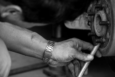 Close-up of man repairing car