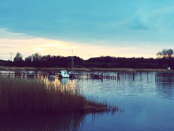 Scenic view of lake against sky at sunset