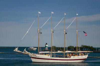 Sailboat sailing in sea against sky