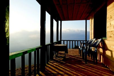 Chairs in balcony on sunny day during foggy weather