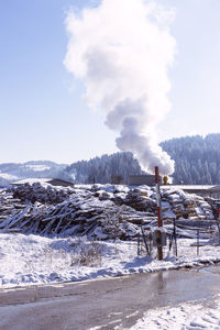 Industrial air pollution at beautiful rural nature in winter