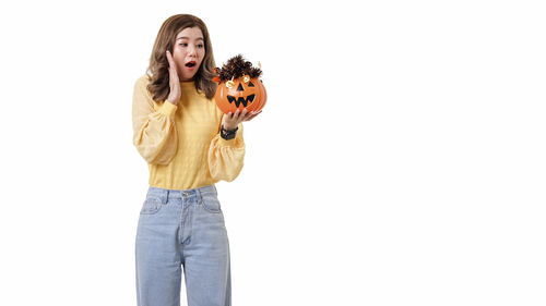 Portrait of a young woman against white background