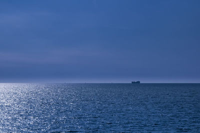 Scenic view of sea against blue sky