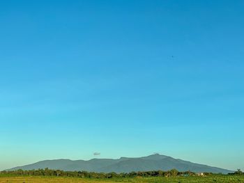 Scenic view of mountains against clear blue sky