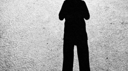 Shadow of child standing on ground