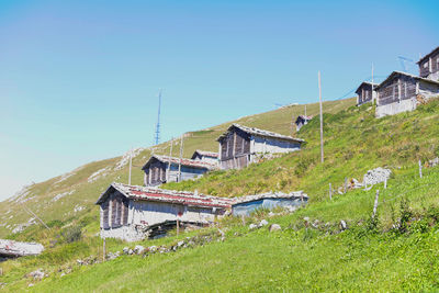 House on field against clear sky