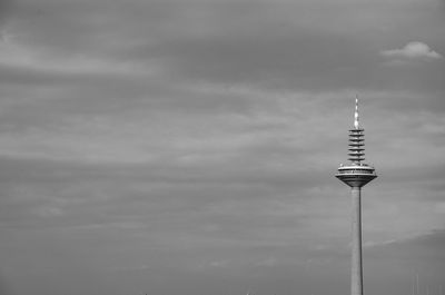 Communications tower against sky in black and white