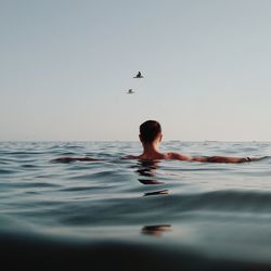 Full length of a young man swimming in sea