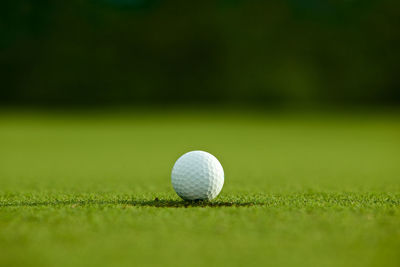 Close-up of golf ball on playing field