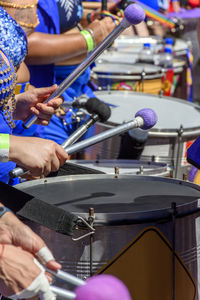 Rear view of man playing drum