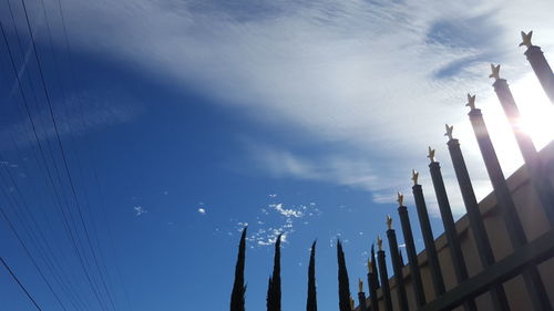 Low angle view of skyscraper against blue sky