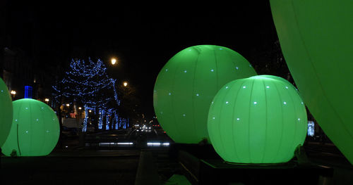 Illuminated lights against sky at night