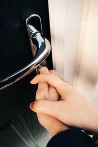 Hands of couple opening front door with key