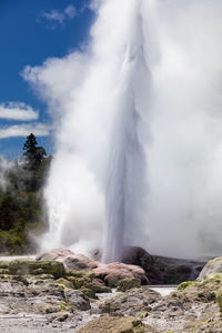 Scenic view of waterfall against sky