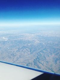Aerial view of landscape against blue sky