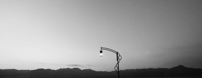 Silhouette mountain against clear sky at dusk