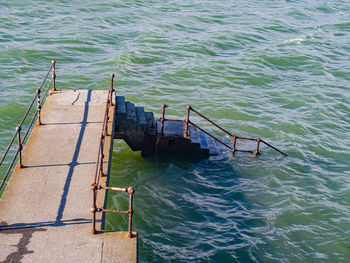 High angle view of abandoned pier over sea