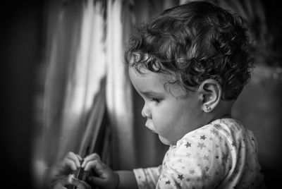 Close-up of cute baby girl at home