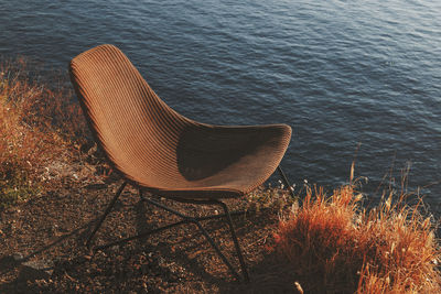 High angle view of empty bench by lake