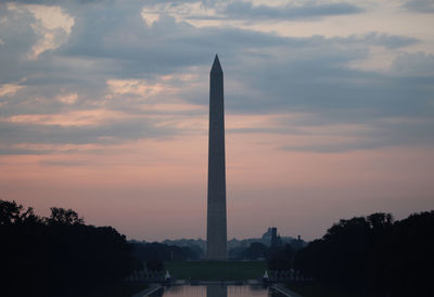 Low angle view of tower against cloudy sky