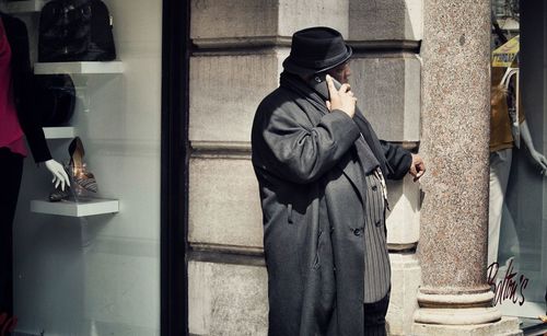 Close-up of woman standing against wall