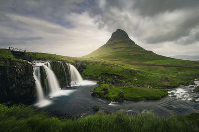 Scenic view of waterfall against sky