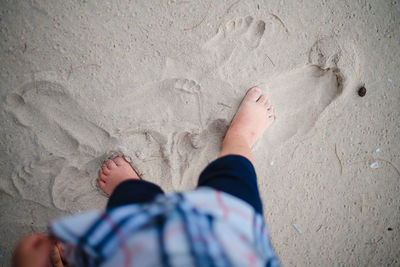 Low section of child on sand
