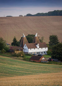 Houses on field against sky